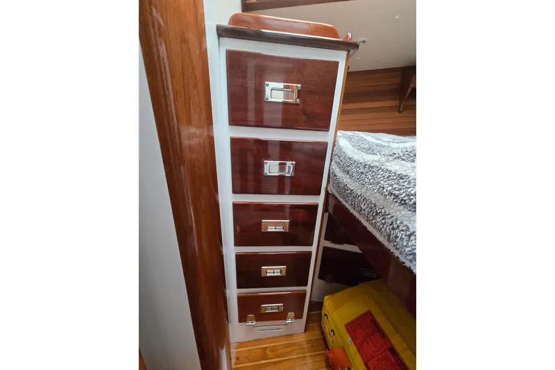 Slide: The Image of Wooden drawers inside a 1970 Hinckley Bermuda 40 yacht, showcasing classic nautical craftsmanship. - 65