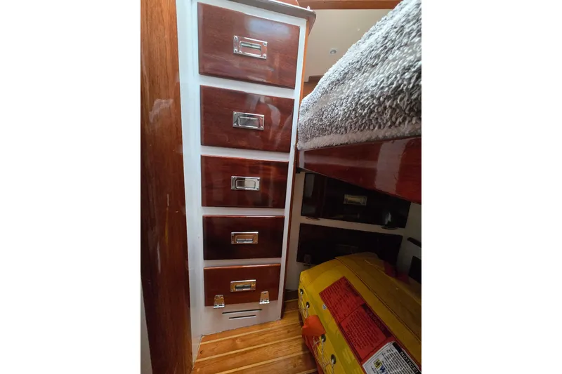 Slide: The Image of Interior of 1970 Hinckley Bermuda 40 with wooden drawers and cozy bedding. - 67