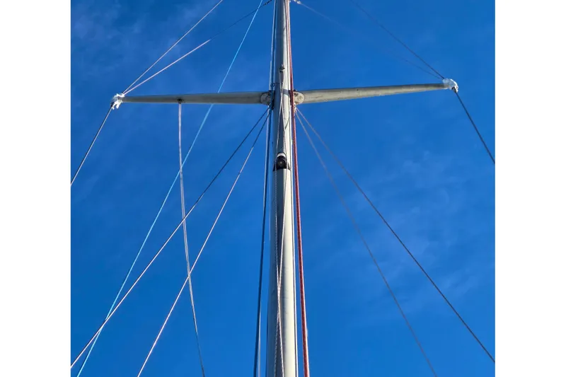 Slide: The Image of Mast and rigging of a 1970 Hinckley Bermuda 40 sailboat against a clear blue sky. - 69