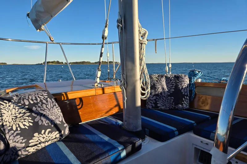 Slide: The Image of Hinckley Bermuda 40 sailboat interior with cushions, sailing on a sunny day, 1970 model. - 74