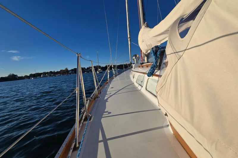 Slide: The Image of 1970 Hinckley Bermuda 40 sailboat deck with clear blue sky and calm waters. - 81