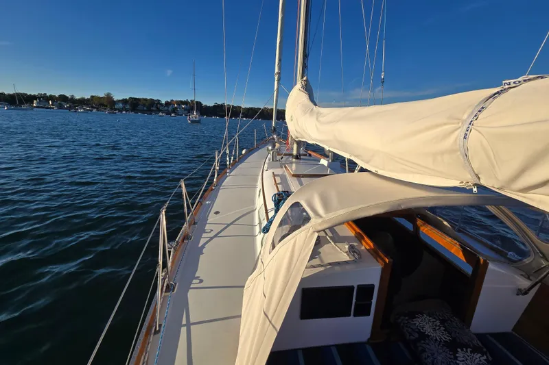Slide: The Image of 1970 Hinckley Bermuda 40 sailboat on calm waters under clear blue sky. - 82
