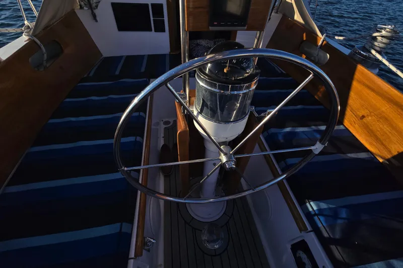 Slide: The Image of Cockpit of 1970 Hinckley Bermuda 40 sailboat with steering wheel and compass. - 85