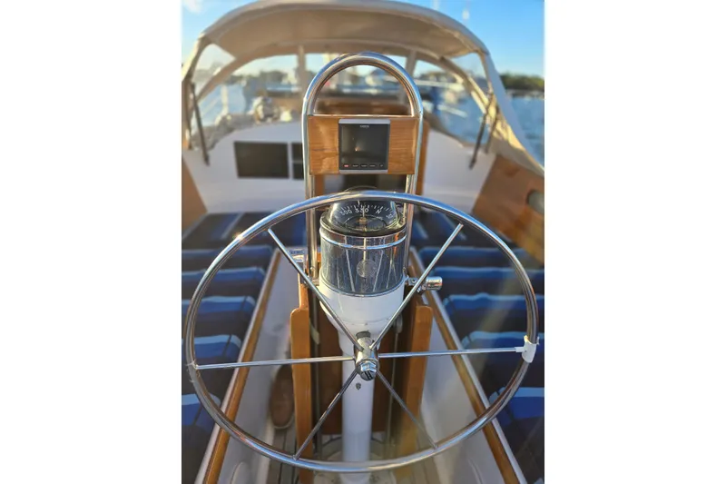 Slide: The Image of Steering wheel of a 1970 Hinckley Bermuda 40 sailboat with compass and navigation equipment. - 86