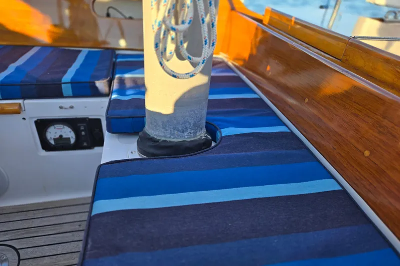 Slide: The Image of Hinckley Bermuda 40 sailboat interior with striped cushions and wooden trim, 1970 model. - 87