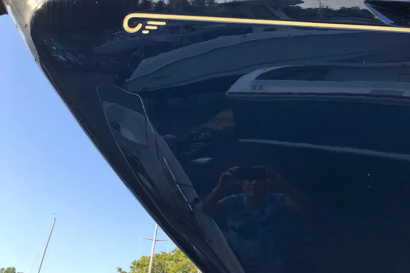 Slide: The Image of Close-up of a 1970 Hinckley Bermuda 40 yacht hull with reflection. - 9