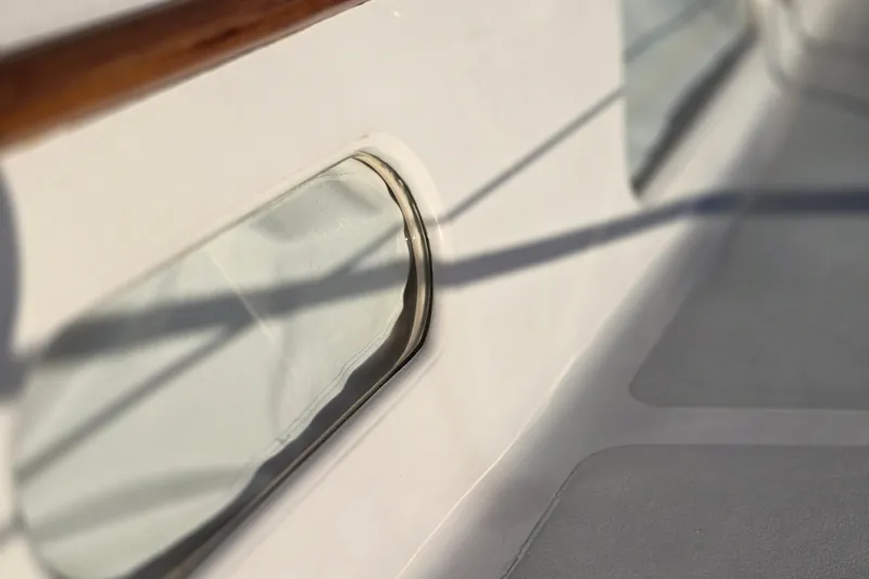 Slide: The Image of Close-up of a 1970 Hinckley Bermuda 40 yacht window with wooden trim. - 92