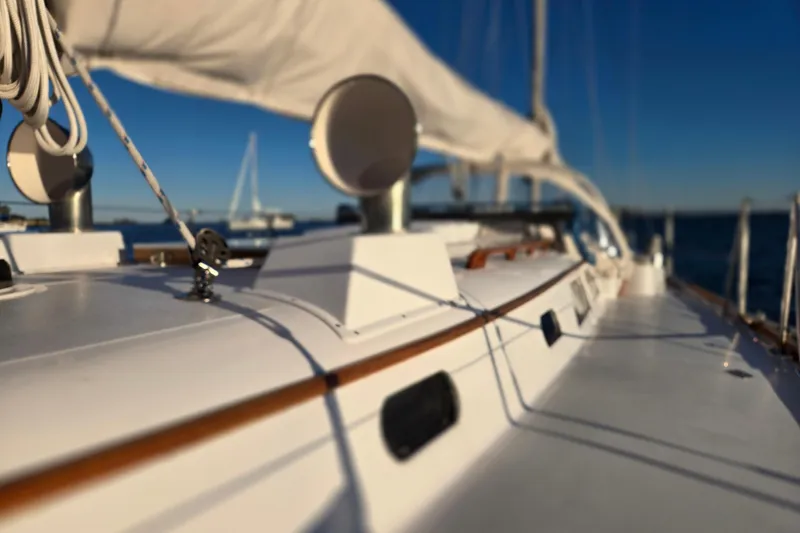 Slide: The Image of 1970 Hinckley Bermuda 40 sailboat deck with rigging, under clear blue sky. - 95