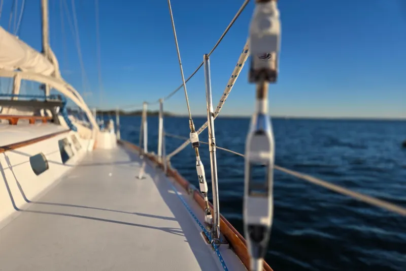 Slide: The Image of 1970 Hinckley Bermuda 40 sailboat deck with ocean view and clear blue sky. - 96