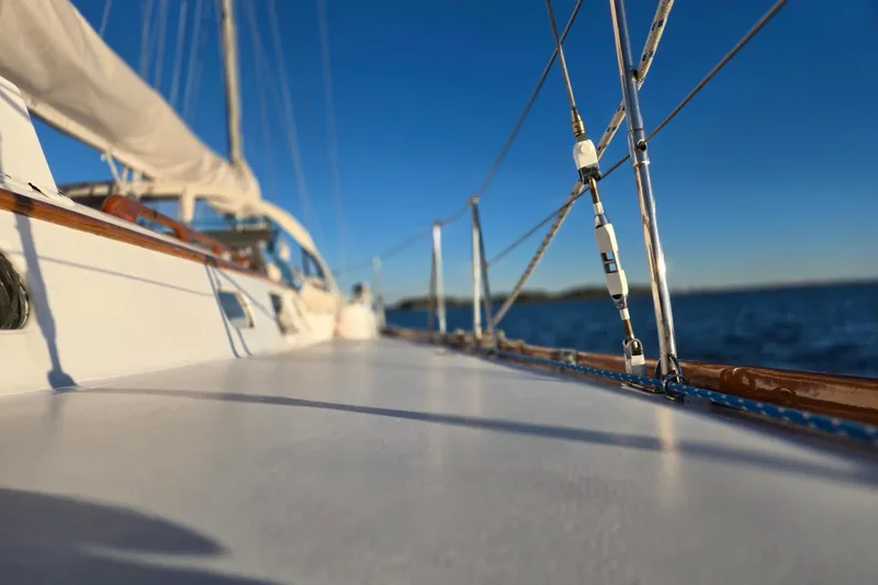 Slide: The Image of 1970 Hinckley Bermuda 40 sailboat deck with rigging, sailing on calm blue waters. - 97