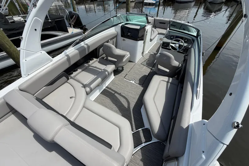 Slide: The Image of 2022 Four Winns HD8 OB boat interior with sleek seating and modern dashboard. - 10