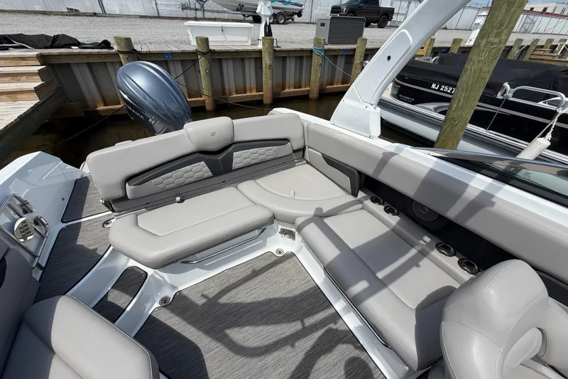 Slide: The Image of 2022 Four Winns HD8 OB boat interior with gray seating and modern design. - 11