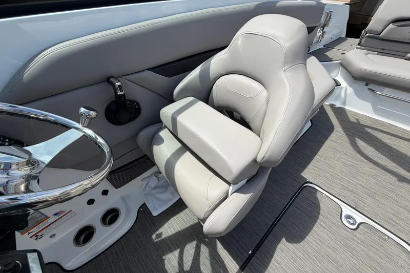 Slide: The Image of 2022 Four Winns HD8 OB boat interior with steering wheel and plush seating. - 17