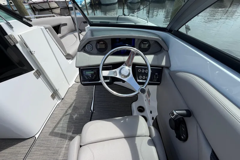 Slide: The Image of 2022 Four Winns HD8 OB boat docked with Yamaha outboard motor, covered in black tarp. - 3