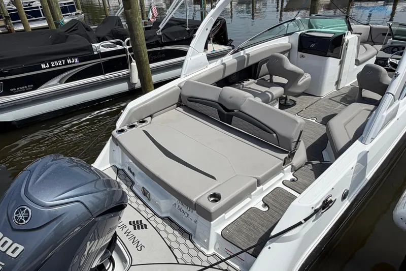 Slide: The Image of 2022 Four Winns HD8 OB boat with Yamaha engine, docked at marina. - 8
