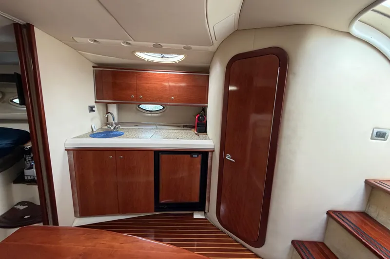 Slide: The Image of Interior of 2007 Monterey 350 Sport Yacht with kitchenette and wooden cabinetry. - 14