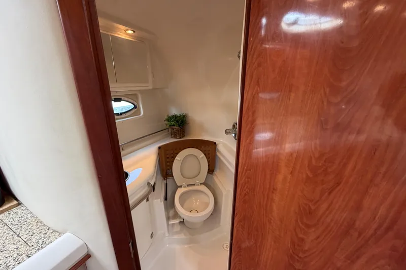 Slide: The Image of Interior of 2007 Monterey 350 Sport Yacht bathroom with wooden door and compact design. - 23