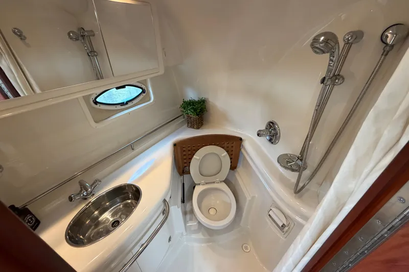 Slide: The Image of Compact bathroom in 2007 Monterey 350 Sport Yacht with shower, sink, and toilet. - 24