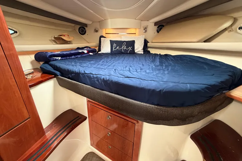 Slide: The Image of Luxurious cabin interior of 2007 Monterey 350 Sport Yacht with cozy bedding and wooden accents. - 30