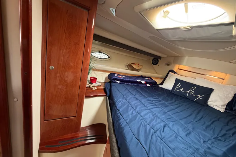 Slide: The Image of Luxurious cabin interior of 2007 Monterey 350 Sport Yacht with cozy bedding and wooden cabinetry. - 31