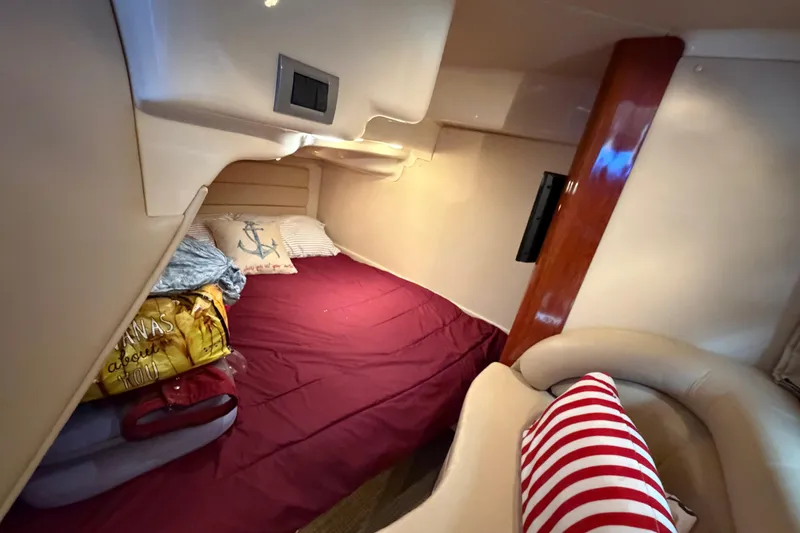 Slide: The Image of Cozy cabin interior of 2007 Monterey 350 Sport Yacht with red bedding and nautical decor. - 36