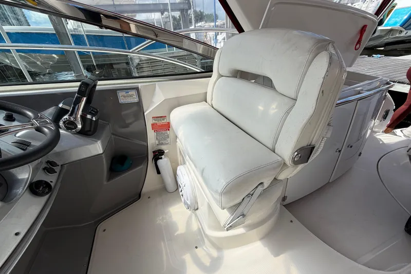 Slide: The Image of Captain's seat and helm of a 2007 Monterey 350 Sport Yacht, featuring steering controls. - 46