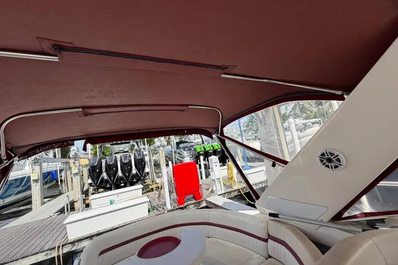 Slide: The Image of Interior view of a 2007 Monterey 350 Sport Yacht with maroon canopy at a marina. - 50