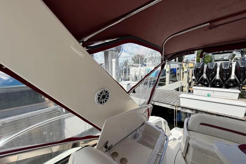 Slide: The Image of Interior view of a 2007 Monterey 350 Sport Yacht with maroon canopy and docked boats. - 51