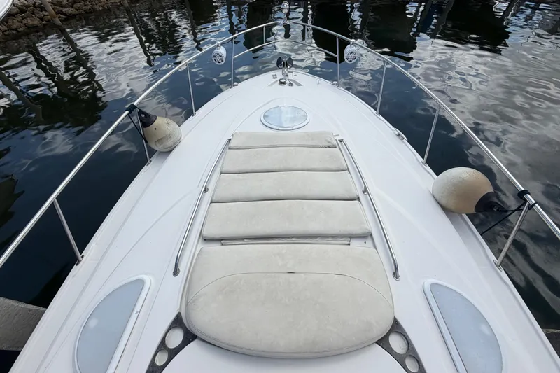 Slide: The Image of Bow view of 2007 Monterey 350 Sport Yacht with sunpad and railings, docked on calm water. - 56
