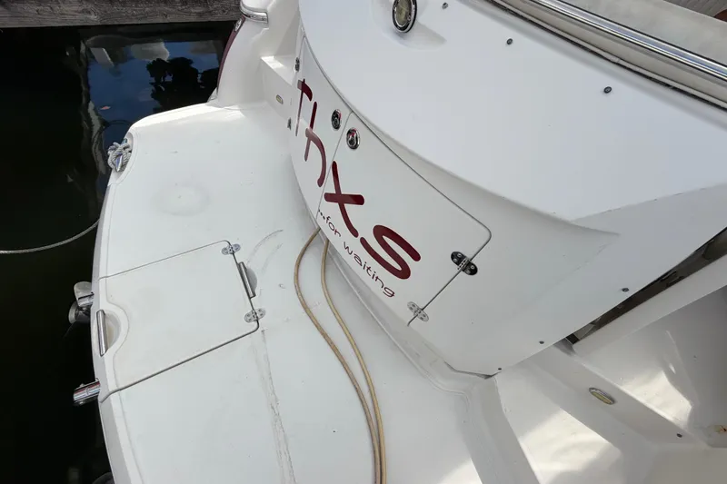 Slide: The Image of 2007 Monterey 350 Sport Yacht stern view with docked platform and water reflection. - 8