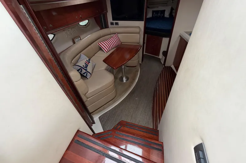 Slide: The Image of Interior of 2007 Monterey 350 Sport Yacht with cozy seating and wooden accents. - 9