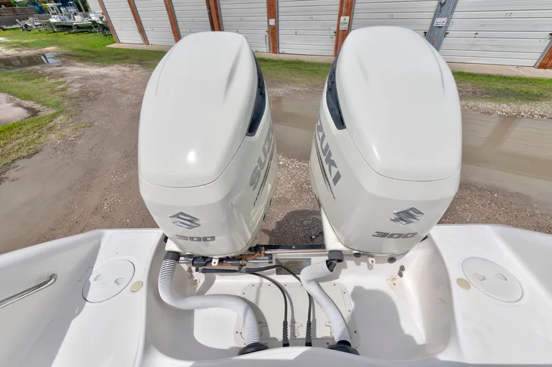 Slide: The Image of Twin Suzuki 300 engines on a 2003 Boston Whaler 270 Outrage boat. - 13