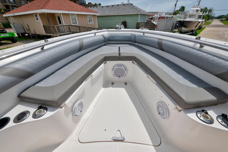 Slide: The Image of 2003 Boston Whaler 270 Outrage boat interior with cushioned seating and speakers. - 15