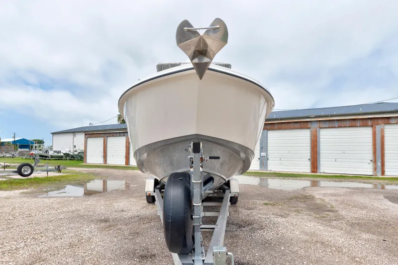 Slide: The Image of 2003 Boston Whaler 270 Outrage boat on trailer, parked outdoors near storage units. - 3