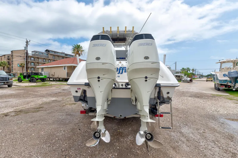 Slide: The Image of 2003 Boston Whaler 270 Outrage with dual 300 horsepower engines, parked outdoors. - 4