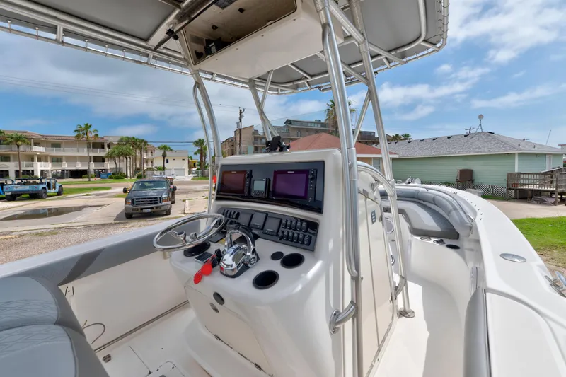 Slide: The Image of 2003 Boston Whaler 270 Outrage boat cockpit with modern navigation equipment and steering wheel. - 6