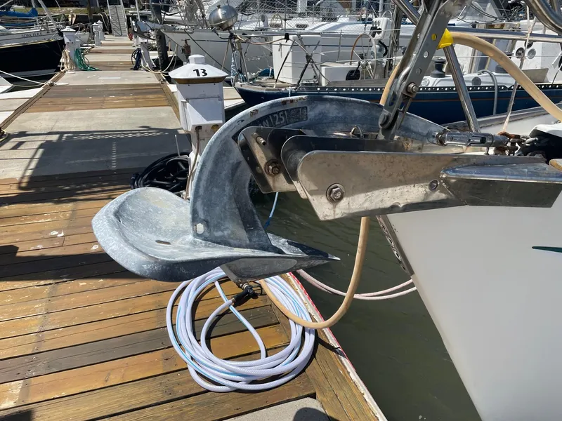 Slide: The Image of Anchor of a 1997 Beneteau Oceanis 461 yacht docked at a marina. - 18