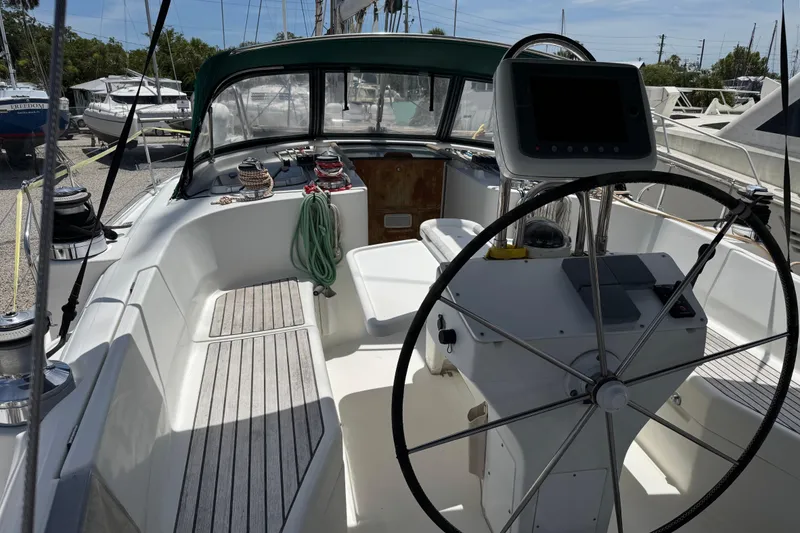 Slide: The Image of Cockpit of a 1997 Beneteau Oceanis 461 sailboat with steering wheel and navigation equipment. - 19