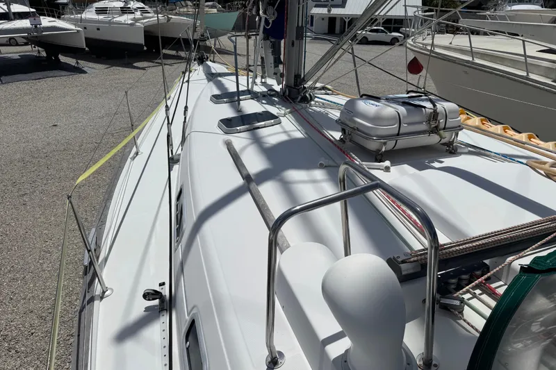 Slide: The Image of 1997 Beneteau Oceanis 461 sailboat deck with liferaft, docked in a marina. - 20