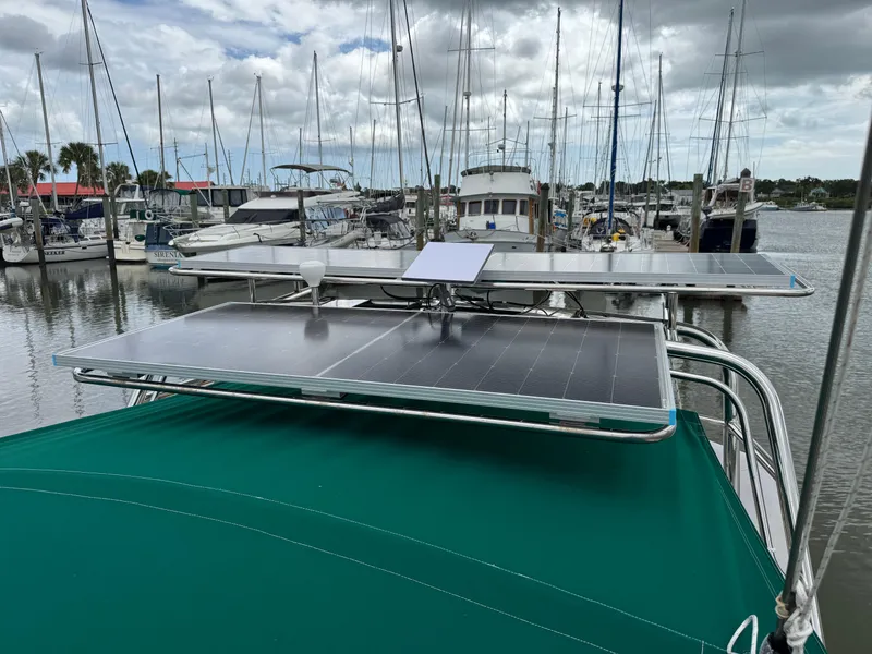 Slide: The Image of Beneteau Oceanis 461 sailboat with solar panels docked at a marina, 1997 model. - 21