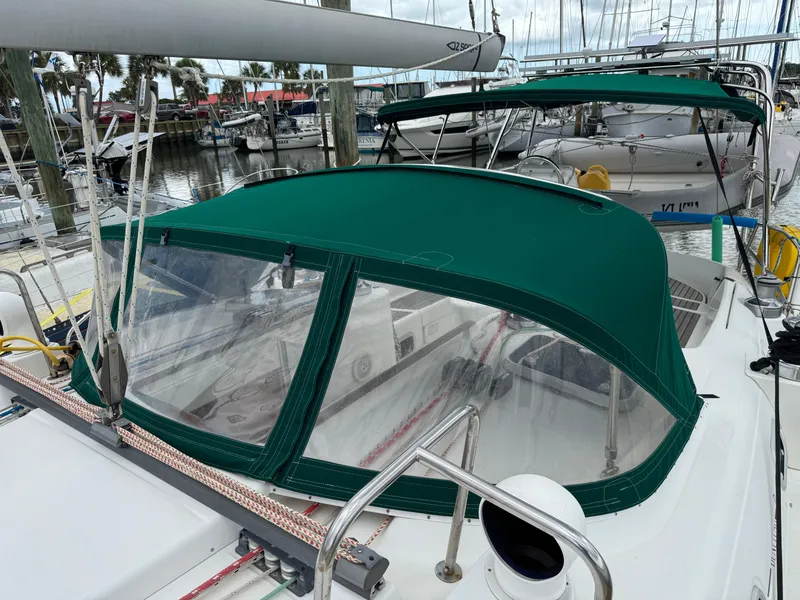 Slide: The Image of Beneteau Oceanis 461 sailboat, 1997 model, with green canopy docked at marina. - 25