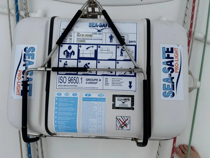 Slide: The Image of Life raft on 1997 Beneteau Oceanis 461 sailboat, labeled "SEA-SAFE PRO-LIGHT" with safety instructions. - 27