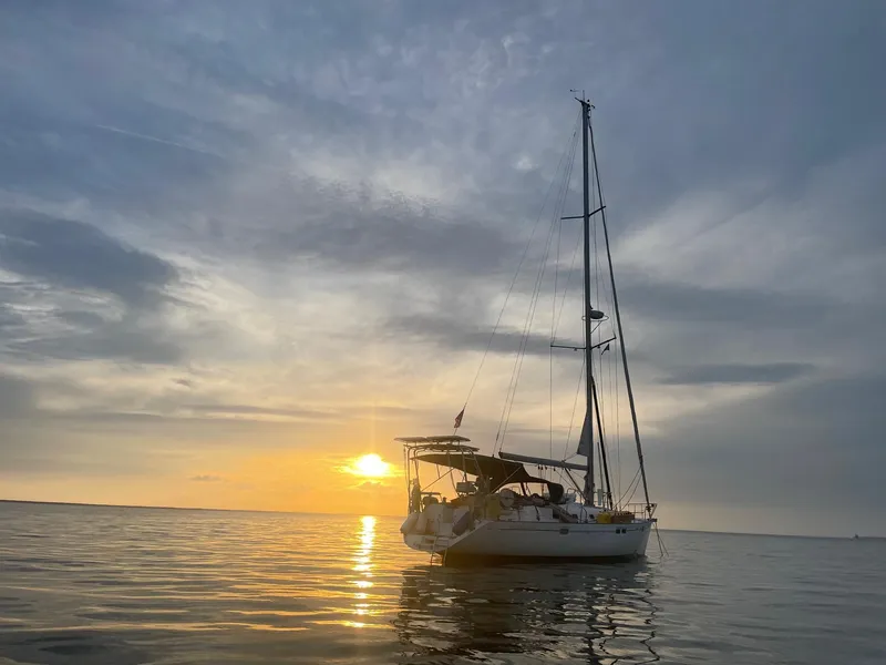 Slide: The Image of Sailboat Beneteau Oceanis 461, 1997 model, at sunset on calm waters. - 3