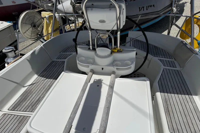 Slide: The Image of Cockpit of a 1997 Beneteau Oceanis 461 sailboat with steering wheel and seating area. - 32