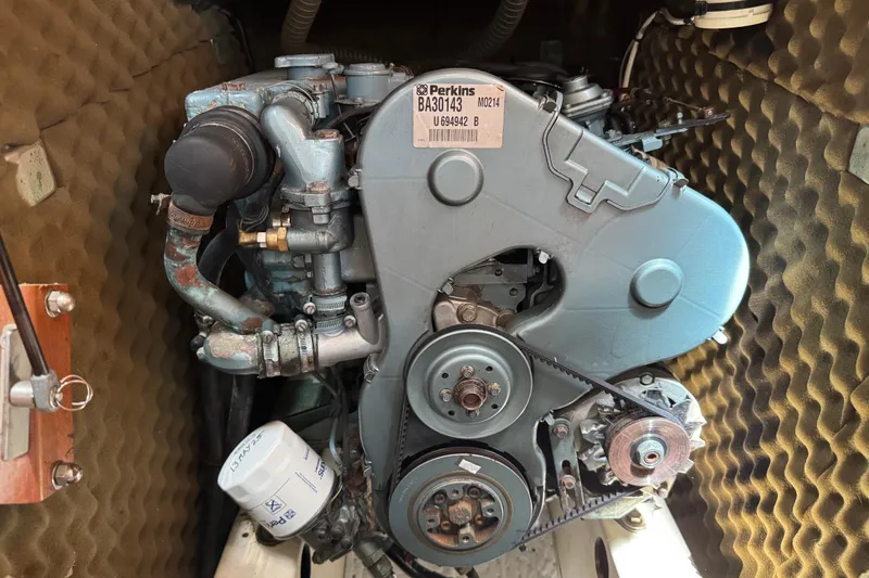 Slide: The Image of Perkins engine inside a 1997 Beneteau Oceanis 461 sailboat, showcasing mechanical components. - 37