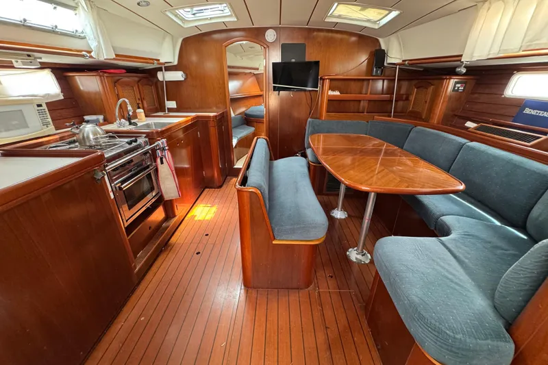 Slide: The Image of Interior of 1997 Beneteau Oceanis 461 yacht with kitchen and dining area. - 5