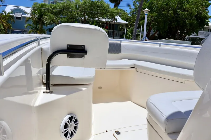 Slide: The Image of 2022 Cobia 301 Center Console boat interior with white seating and speaker. - 11