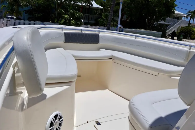 Slide: The Image of 2022 Cobia 301 Center Console boat interior with cushioned seating and speaker. - 12