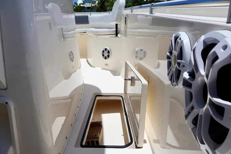Slide: The Image of 2022 Cobia 301 Center Console interior with speakers and storage compartments. - 13