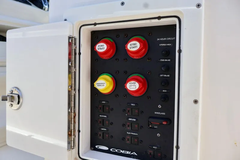 Slide: The Image of Control panel of 2022 Cobia 301 Center Console boat with labeled switches and buttons. - 14